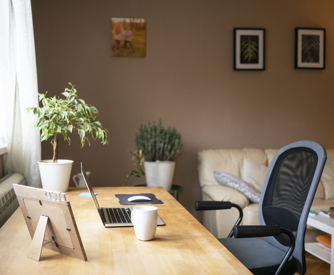 desk chair and laptop on a desk in a home office space