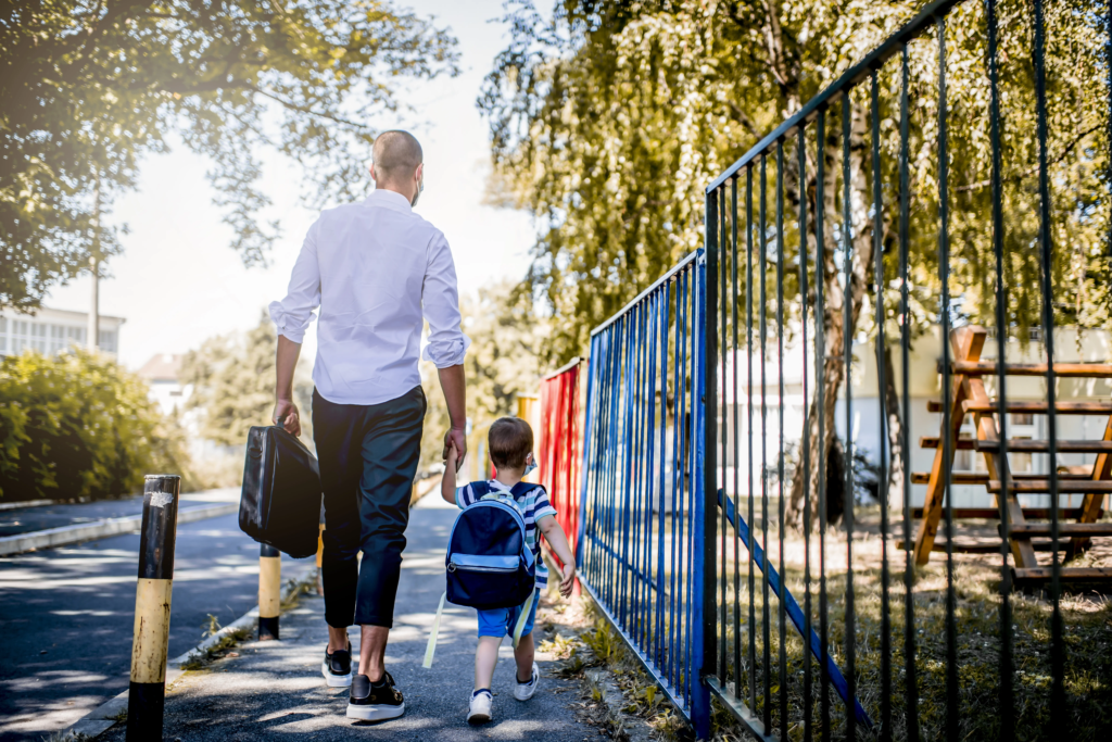 A father walking his child to school
