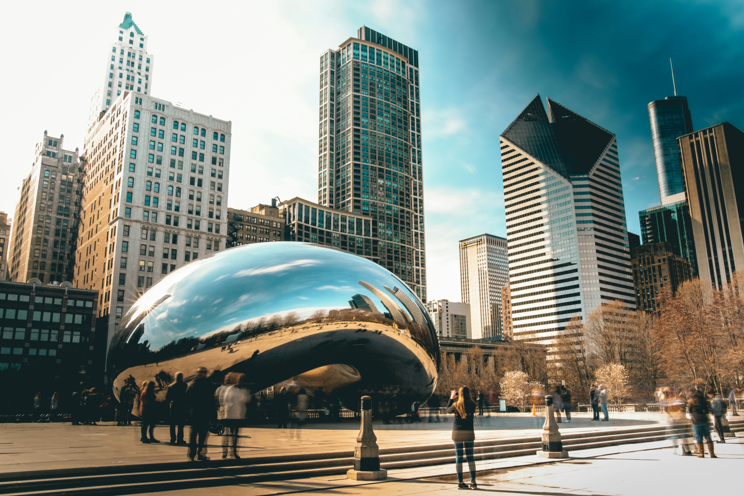 Tourists visiting The Bean in Chicago during summer vacation.